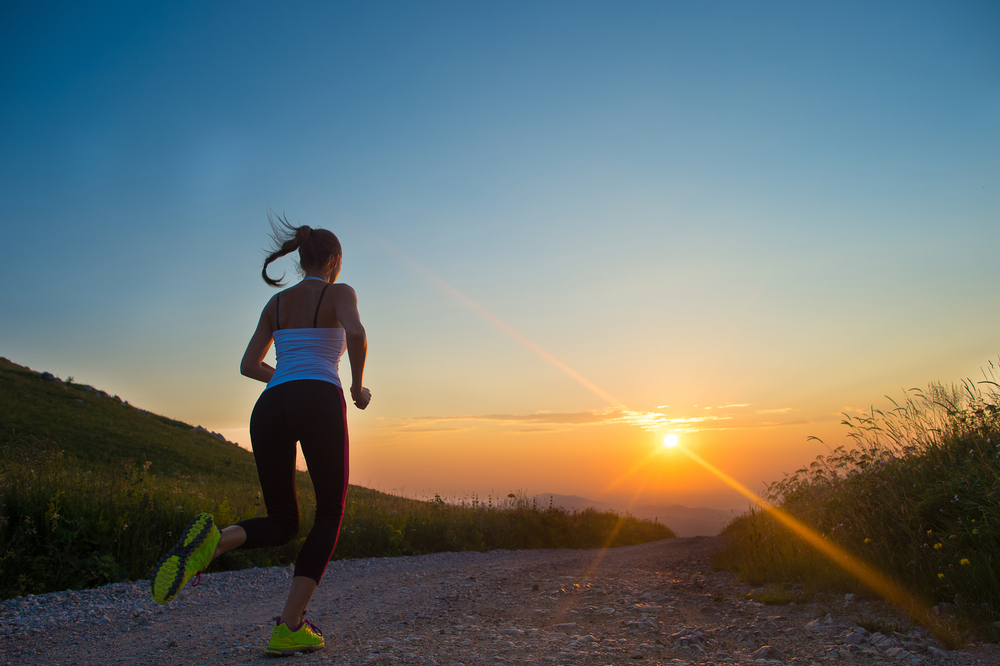 Girl running at sunset.
